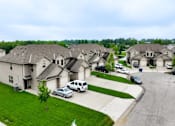Thumbnail 16 of 47 - A row of houses with cars parked in front.