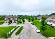 Thumbnail 23 of 47 - A residential street with cars parked on the side.
