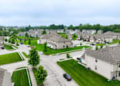 Thumbnail 22 of 47 - A residential area with houses and cars.