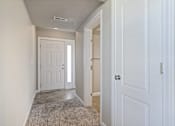 Thumbnail 42 of 47 - A hallway with a white door and a carpeted floor.