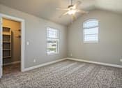 Thumbnail 5 of 47 - A room with a ceiling fan and two windows.