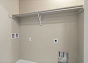 Thumbnail 31 of 47 - A white shelf is mounted on a wall.
