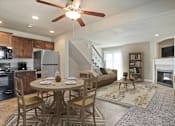 Thumbnail 4 of 47 - A modern kitchen with a dining table set for four.