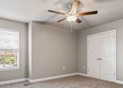 Thumbnail 15 of 23 - A room with a ceiling fan and a window with blinds.