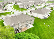 Thumbnail 19 of 23 - A residential area with houses and green lawns.