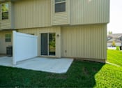 Thumbnail 5 of 23 - A beige house with a white garage door.