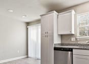 Thumbnail 14 of 23 - A kitchen with a dishwasher and cabinets.