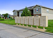 Thumbnail 11 of 28 - A long row of mailboxes in front of a building.
