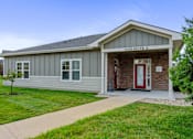 Thumbnail 26 of 28 - A small building with a red door and windows is labeled 4100 SUITE A.