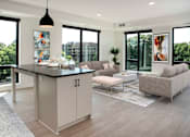 Thumbnail 10 of 79 - A modern kitchen with a large island and a couch.