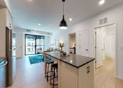 Thumbnail 15 of 79 - A kitchen with a bar and a refrigerator.
