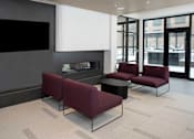 Thumbnail 23 of 79 - An amenity lounge with modern living room with a fireplace and a television.