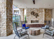 Thumbnail 13 of 29 - A patio with a fireplace and chairs.