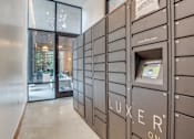 Thumbnail 29 of 29 - A row of Luxeer One mailboxes are lined up on a wall.