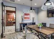 Thumbnail 6 of 32 - A modern dining room with a wooden table and grey chairs.