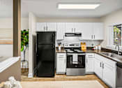 Thumbnail 33 of 41 - A modern kitchen with white cabinets and black appliances.