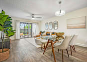 Thumbnail 28 of 41 - A dining room with a glass table and chairs.