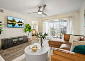 Thumbnail 31 of 41 - A living room with a flat screen TV mounted on the wall.