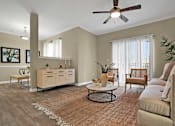 Thumbnail 13 of 41 - A living room with a ceiling fan and a rug on the floor.