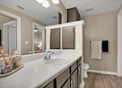 Thumbnail 22 of 41 - A bathroom with a white sink and a white toilet.