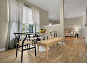 Thumbnail 15 of 41 - A modern dining room with a wooden table and chairs.