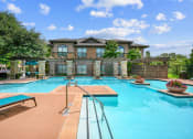 Thumbnail 20 of 48 - a swimming pool with a house in the background