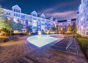 Thumbnail 37 of 39 - an apartment building with a pool at night