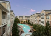 Thumbnail 29 of 39 - an apartment building with a large swimming pool