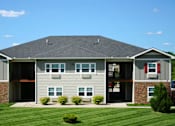 Thumbnail 1 of 28 - A large house with a grey roof and a green lawn in front.