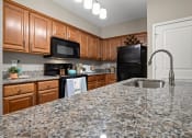 Thumbnail 5 of 48 - Renovated Kitchen with Granite Countertops and Farmhouse Style Sink