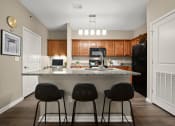Thumbnail 4 of 48 - Kansas City, MO Apartments - Riverstone - Kitchen with Granite-Style Countertops and Kitchen Island