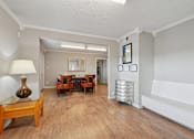 Thumbnail 13 of 19 - A living room with a wooden floor and furniture.