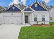 Thumbnail 23 of 26 - a white house with a black door and a driveway