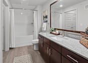 Thumbnail 8 of 47 - A bathroom with a toilet, sink, and mirror.