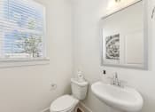 Thumbnail 11 of 25 - a bathroom with a sink and a toilet and a window