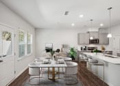 Thumbnail 2 of 25 - an open kitchen and dining room with a table and chairs
