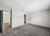 Thumbnail 28 of 35 - A room with a grey carpet and white walls.