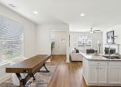 Thumbnail 7 of 25 - a living room with a kitchen and a dining room
