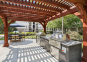 Thumbnail 37 of 47 - a covered patio with two grills and a wooden pavilion