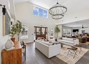 Thumbnail 18 of 26 - A clubhouse with a large sofa set and a chandelier.