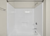 Thumbnail 20 of 25 - A white bathroom with a shower stall and a towel bar.
