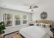 Thumbnail 5 of 25 - a bedroom with white walls and a ceiling fan