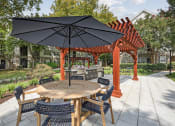 Thumbnail 35 of 47 - a patio with a table and chairs and umbrellas