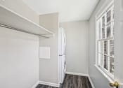 Thumbnail 10 of 15 - A white refrigerator in a room with a window.