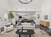 Thumbnail 20 of 26 - A clubhouse with a white couch and a black coffee table.