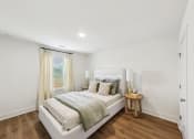 Thumbnail 21 of 25 - a white bedroom with a bed and a window