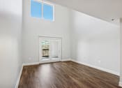 Thumbnail 6 of 27 - A room with a wooden floor and a window.