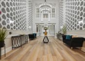 Thumbnail 10 of 25 - the lobby of a hotel with a large hall with chairs and a table