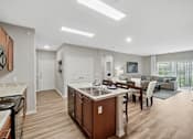 Thumbnail 3 of 32 - A modern kitchen with wooden cabinets and a central island.