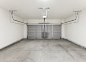 Thumbnail 22 of 26 - the inside of a garage with white walls and a concrete floor